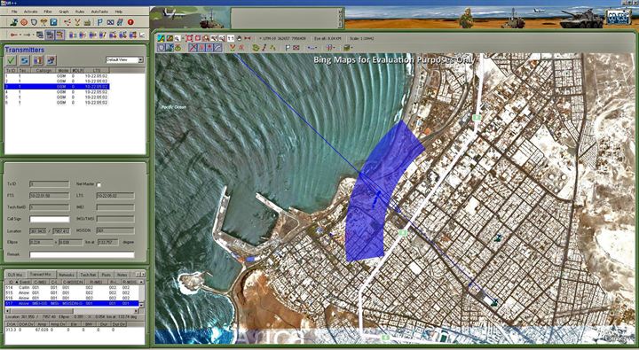 GenCOM UI++ showing a GSM sector beam and bearing lines converging on an emitter in a coastal city
